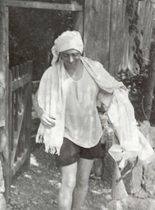 Vertov wearing a turban, with a towel and white trousers in his hand